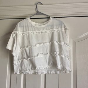This is a half cropped whited ruffle top. Size small.